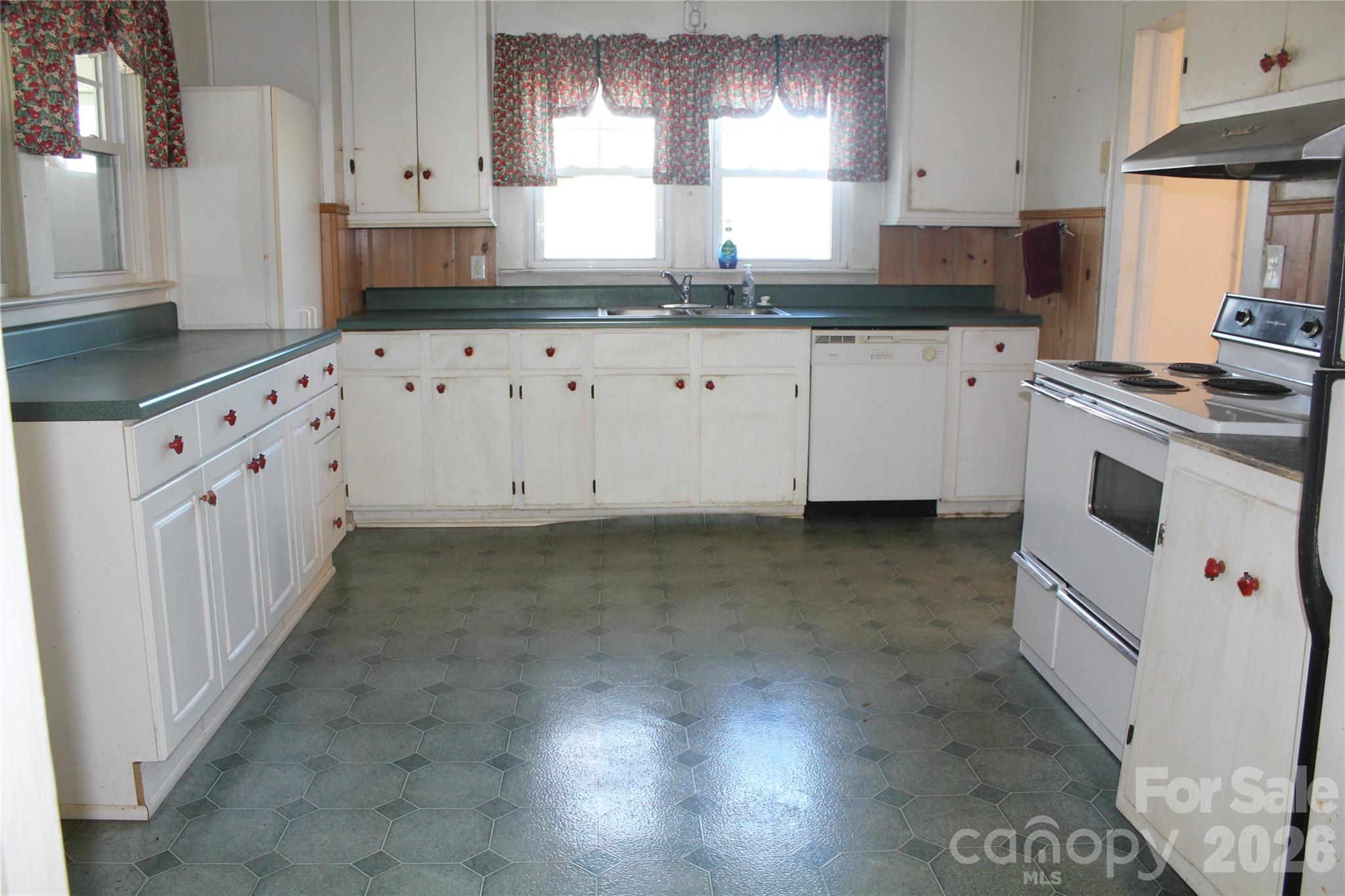 113 Williams Street Morganton, NC 28655 - Photo 16 of 20 a kitchen with granite countertop white cabinets white appliances a sink and a oven