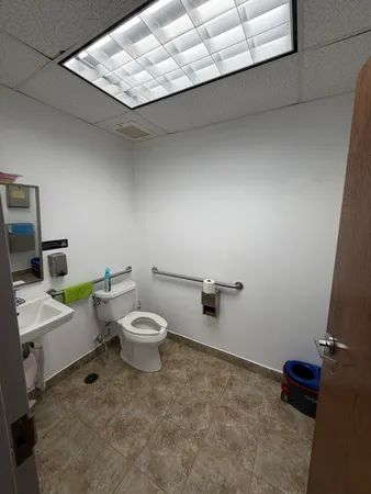 a white toilet sitting next to a bathroom sink