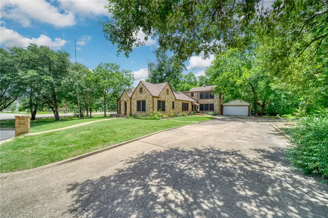 a house with green field in front of it