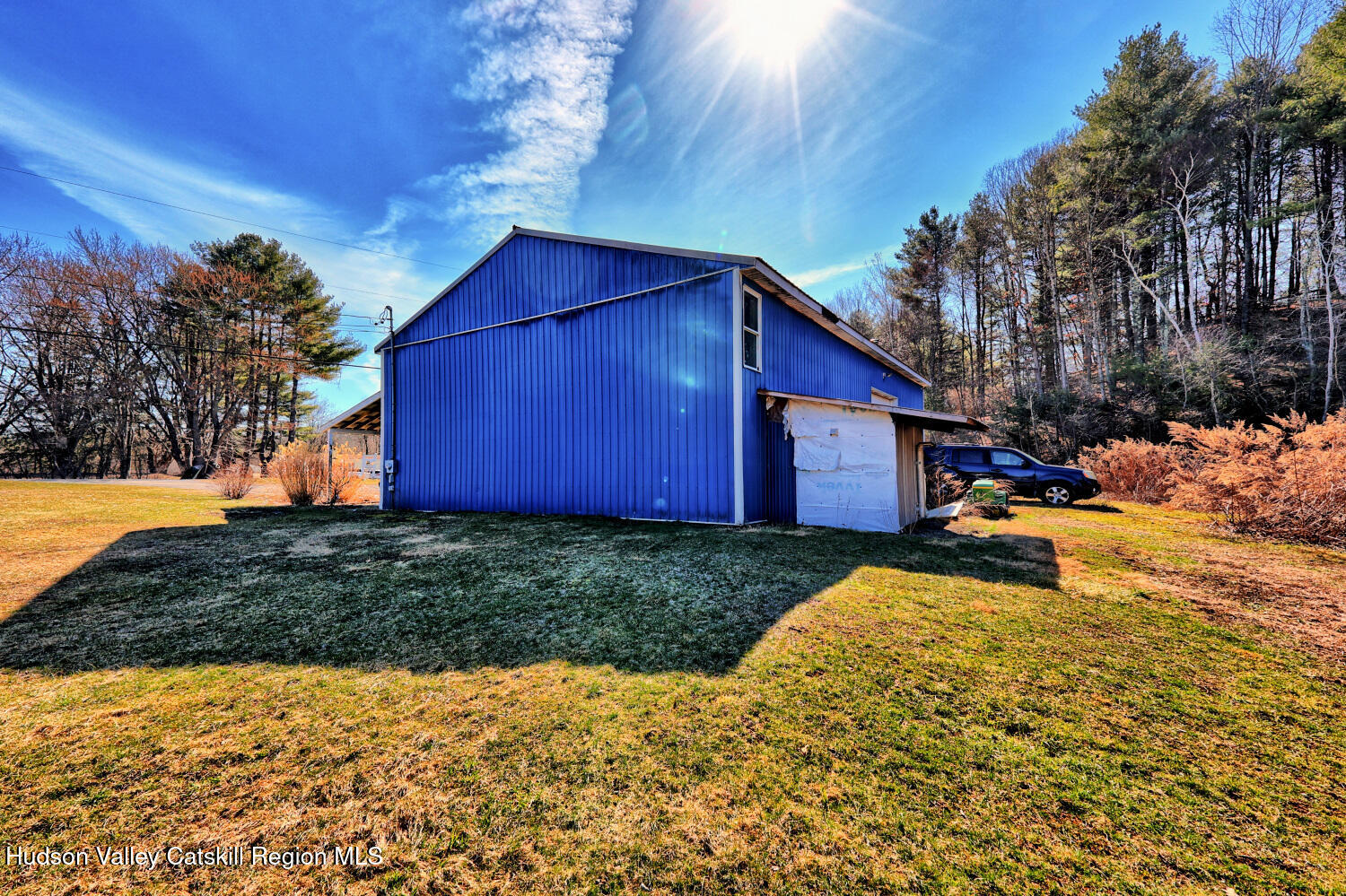 301 Sugar Loaf Road Earlton, NY 12058 - Photo 50 of 64 a view of backyard of house with wooden fence and trees