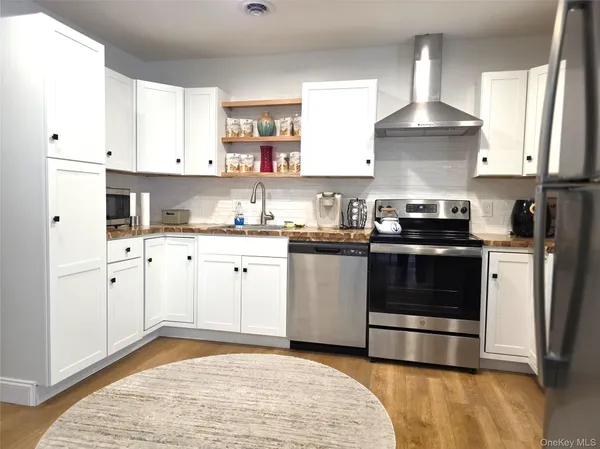 a kitchen with a stove a sink and a refrigerator
