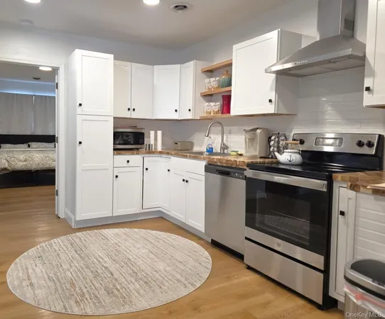 a kitchen with a stove and white cabinets