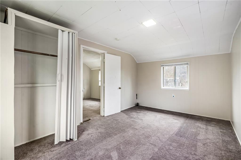 421 High Street McKeesport, PA 15132 - Photo 20 of 23 a view of an empty room with closet and a refrigerator