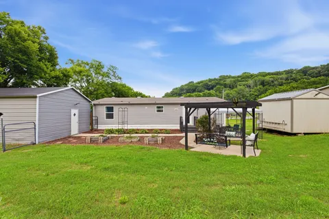 a backyard of a house with table and chairs