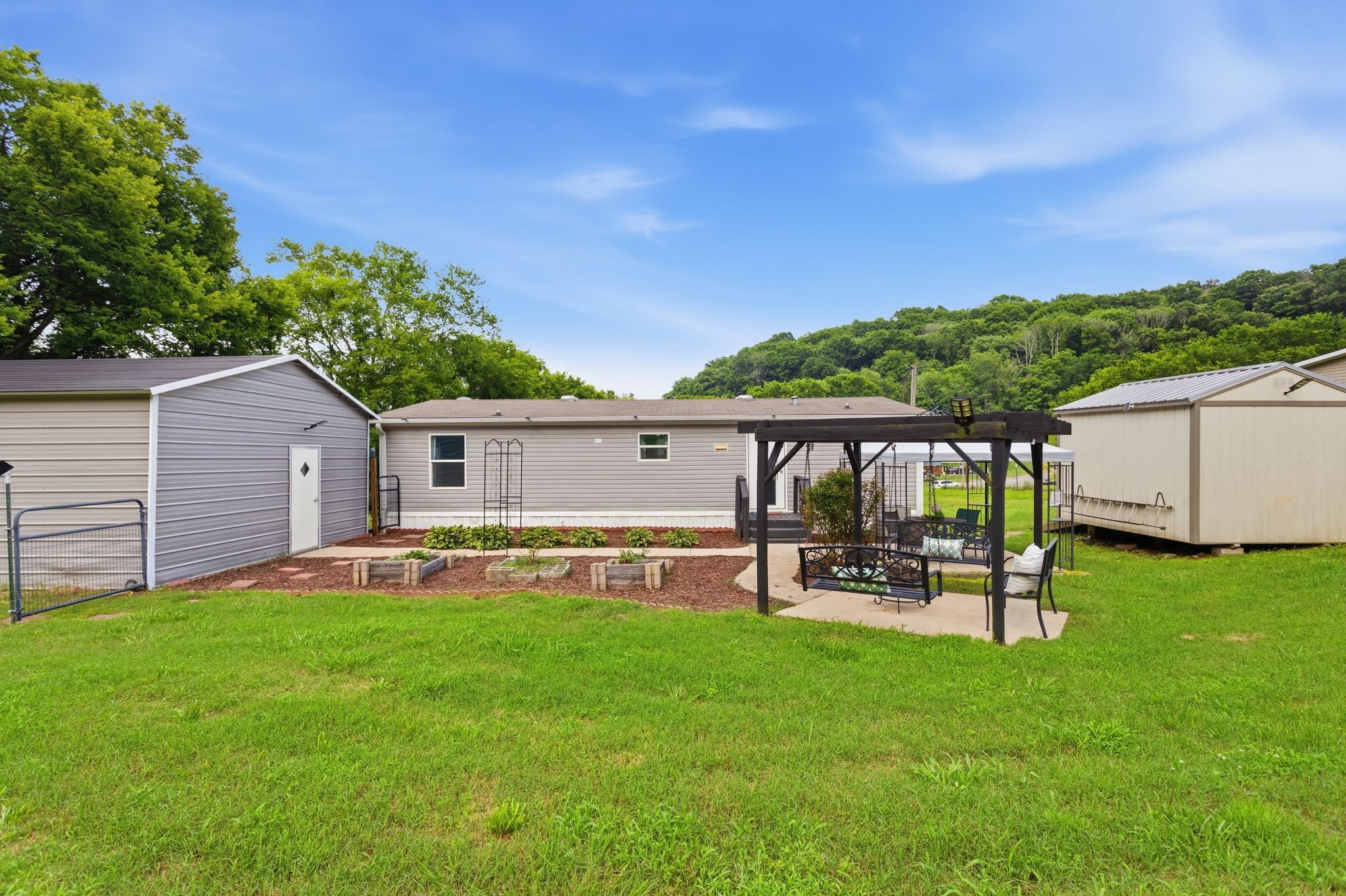 3204 Grizzly Road Culleoka, TN 38451 - Photo 20 of 25 a backyard of a house with table and chairs