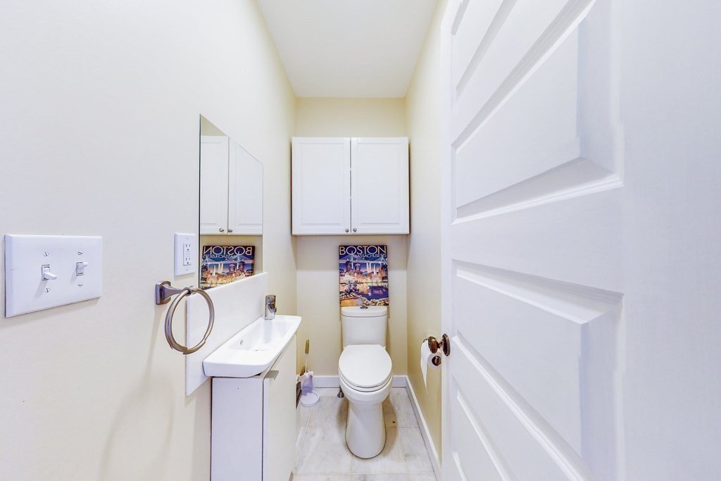 9 Wallingford Road Boston, MA 02135 - Photo 12 of 22 a bathroom with a toilet sink vanity tub and mirror
