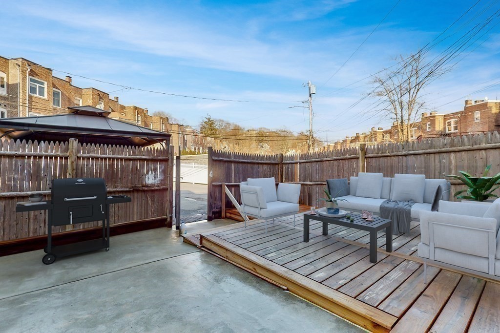 9 Wallingford Road Boston, MA 02135 - Photo 17 of 22 a view of a roof deck with couches