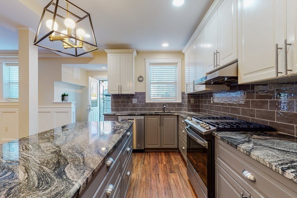 9 Wallingford Road Boston, MA 02135 - Photo 2 of 22 a kitchen with kitchen island granite countertop a stove and a sink