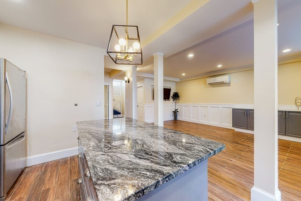 9 Wallingford Road Boston, MA 02135 - Photo 5 of 22 a view of a kitchen with wooden floor and a refrigerator