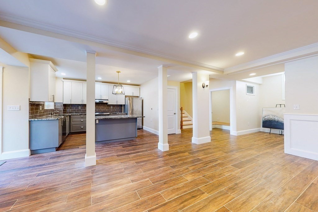 9 Wallingford Road Boston, MA 02135 - Photo 6 of 22 a view of a kitchen with kitchen island wooden floors and stainless steel appliances