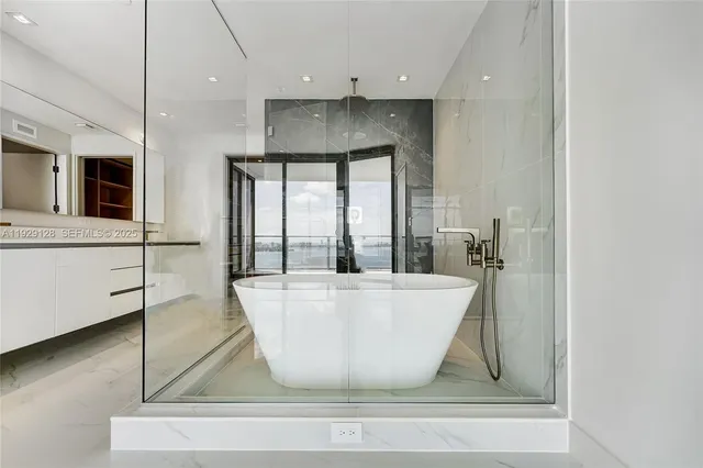a white bath tub sitting in a bathroom