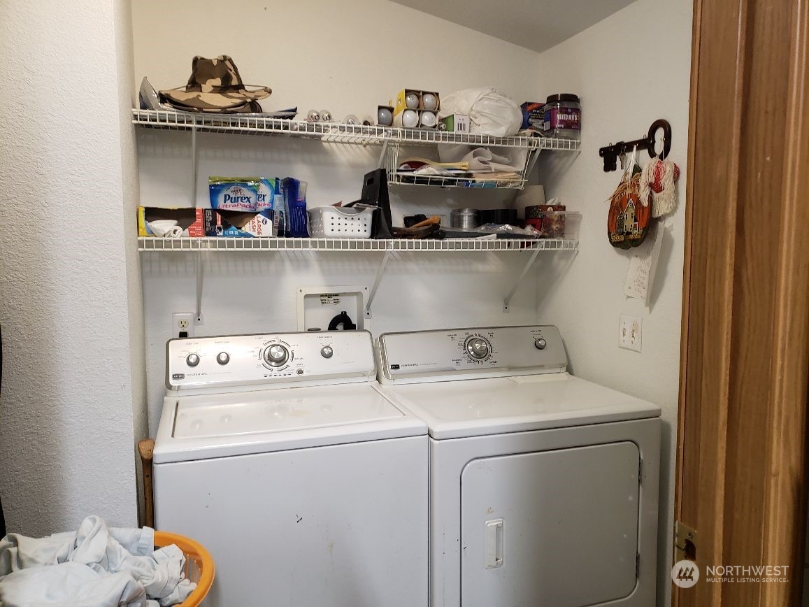 520 Willow Drive, Unit 111 Enumclaw, WA 98022 - Photo 17 of 26 a view of washer and dryer with kitchen in the background