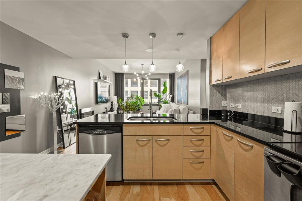 1200 Main Street, Unit 1508 Dallas, TX 75202 - Photo 12 of 16 a kitchen with white cabinets sink and stainless steel appliances