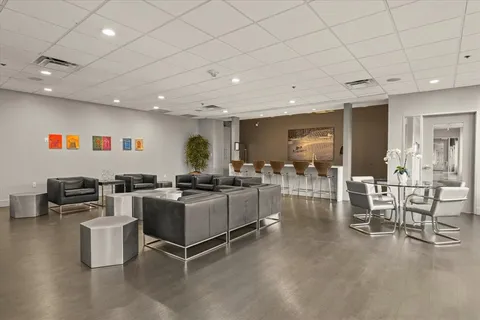 a living room with furniture a window and chairs