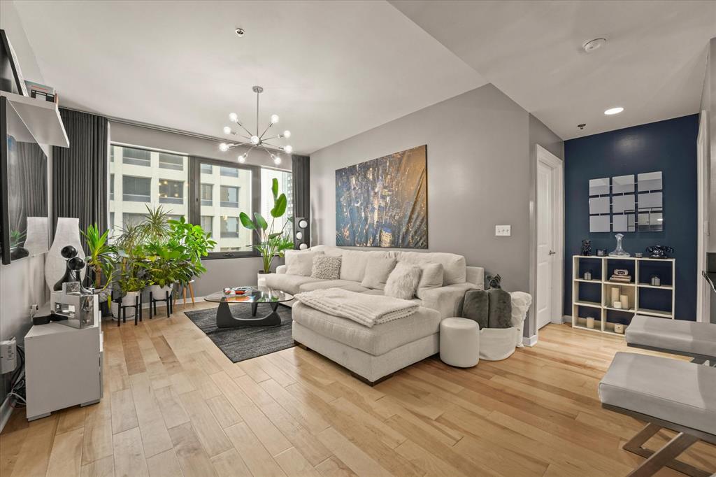 1200 Main Street, Unit 1508 Dallas, TX 75202 - Photo 7 of 16 a living room with furniture and a chandelier