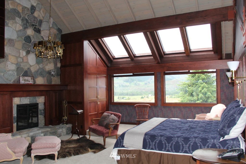 80 Tice Ranch Road Twisp, WA 98856 - Photo 10 of 22 a bedroom with furniture and a large window