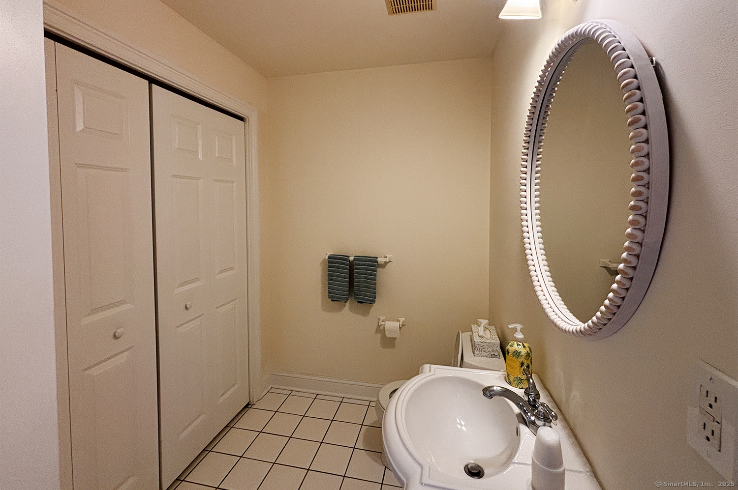 391 South Pine Creek Road Fairfield, CT 06824 - Photo 12 of 25 a bathroom with a sink and a mirror