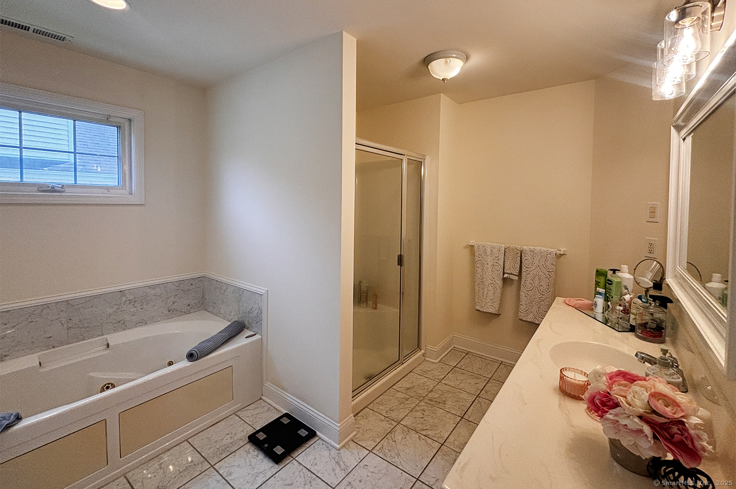 391 South Pine Creek Road Fairfield, CT 06824 - Photo 16 of 25 a bathroom with a tub sink and a mirror