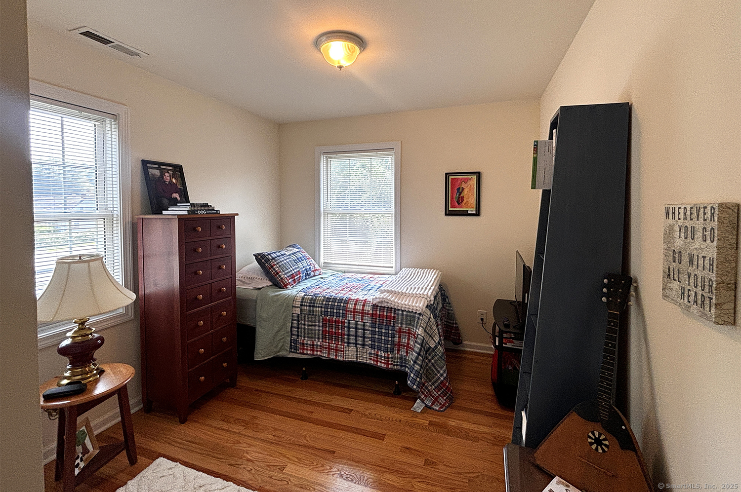 391 South Pine Creek Road Fairfield, CT 06824 - Photo 19 of 25 a bedroom with a bed and wooden floor