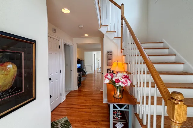 a view of an entryway with wooden floor windows and a livingroom
