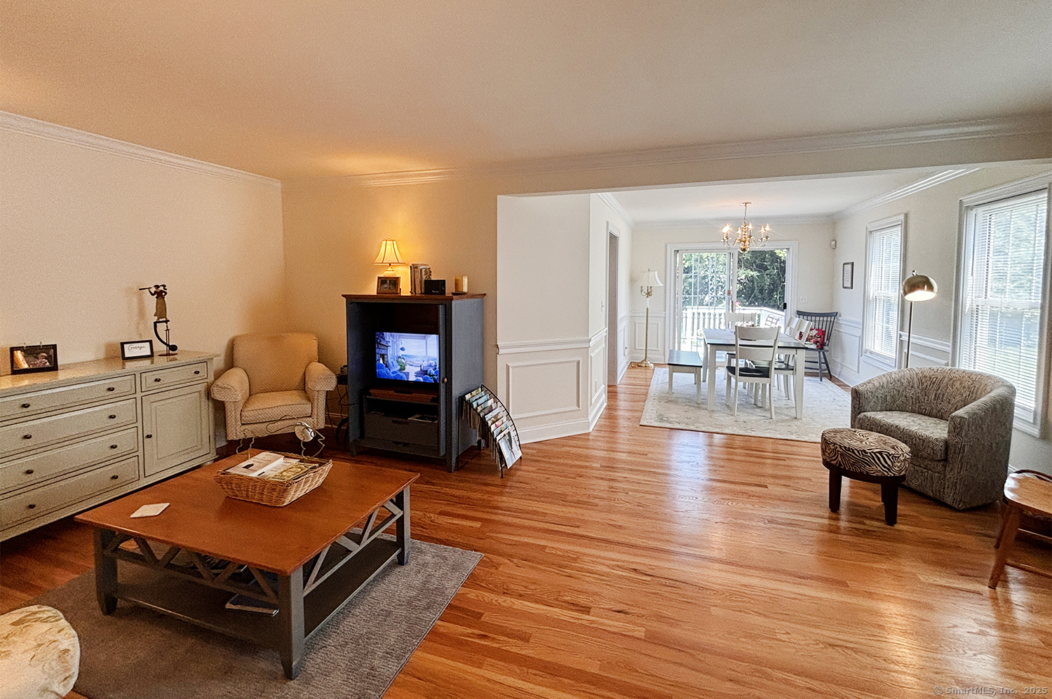 391 South Pine Creek Road Fairfield, CT 06824 - Photo 4 of 25 a living room with furniture a table and wooden floor