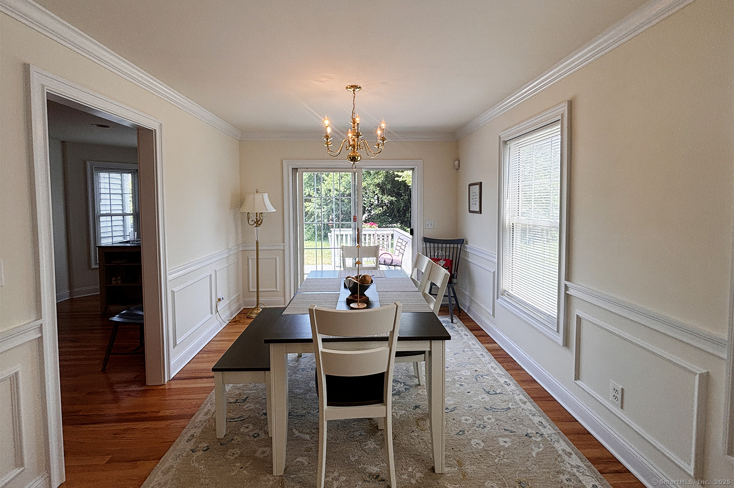 391 South Pine Creek Road Fairfield, CT 06824 - Photo 7 of 25 a dining room with furniture a chandelier and wooden floor