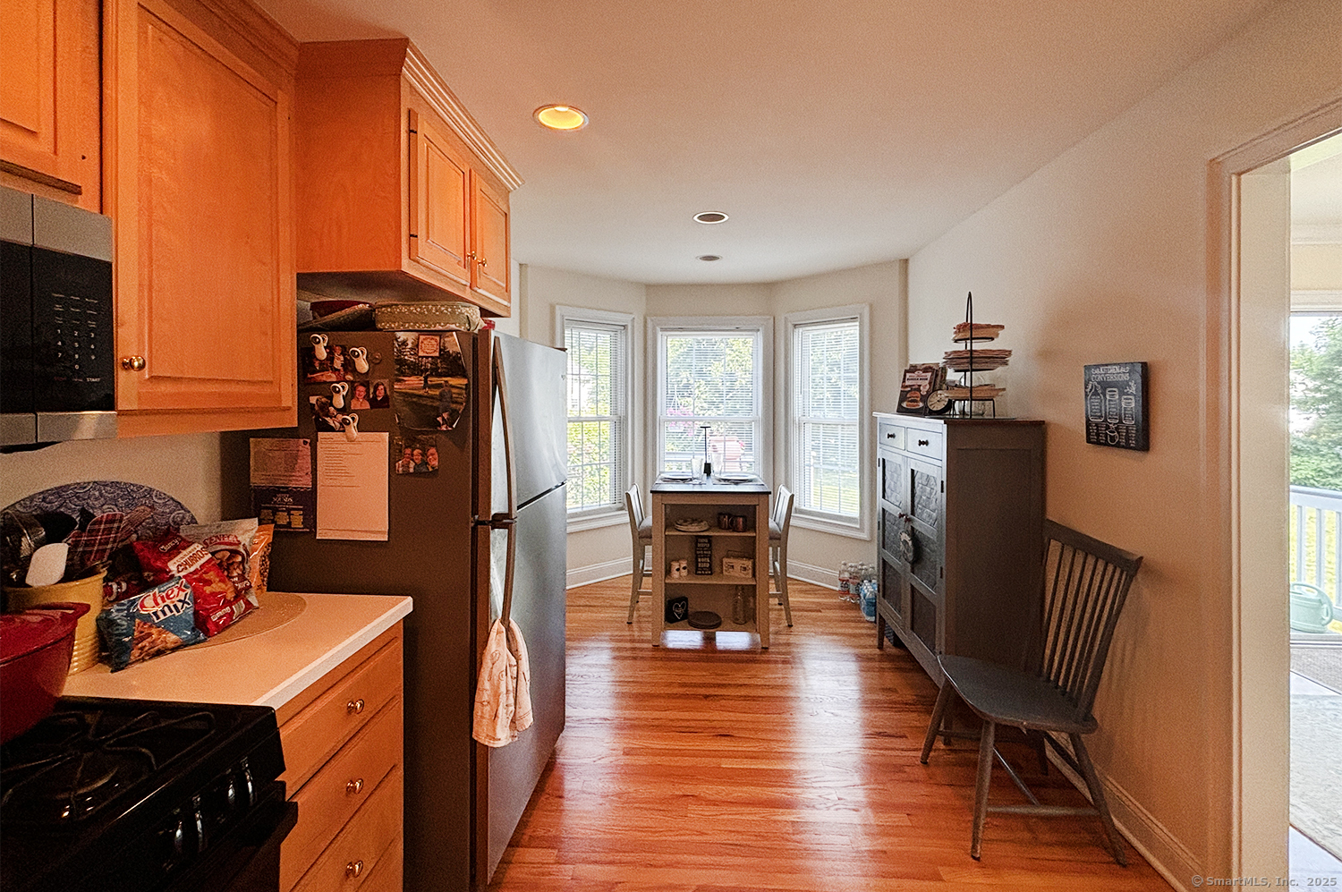 391 South Pine Creek Road Fairfield, CT 06824 - Photo 10 of 25 a view of a kitchen with fridge and wooden floor