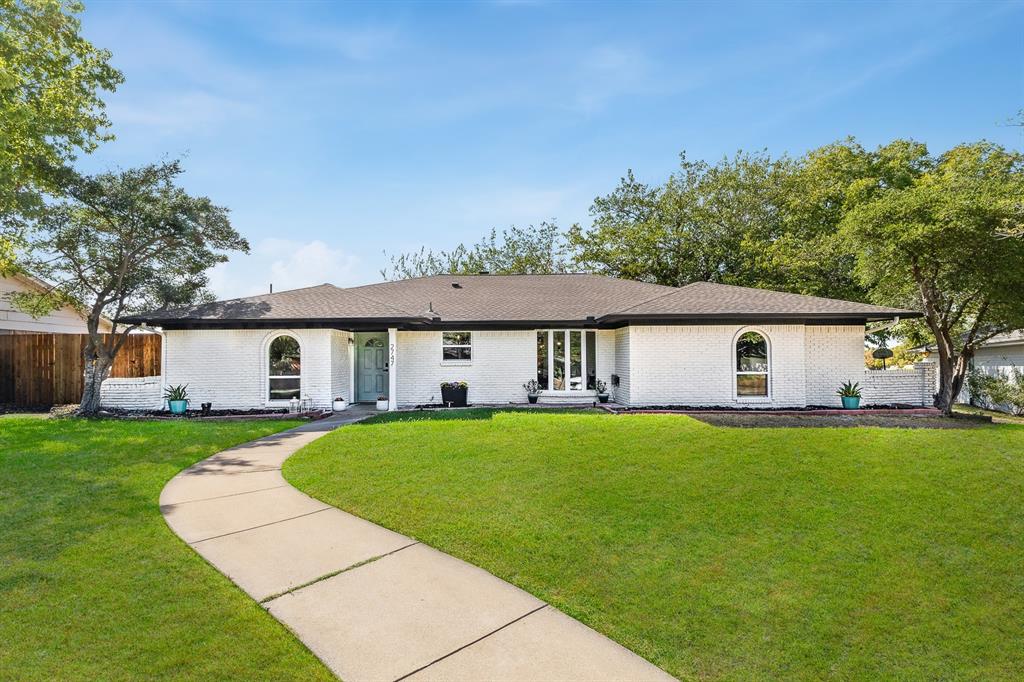 a front view of house with yard and trees