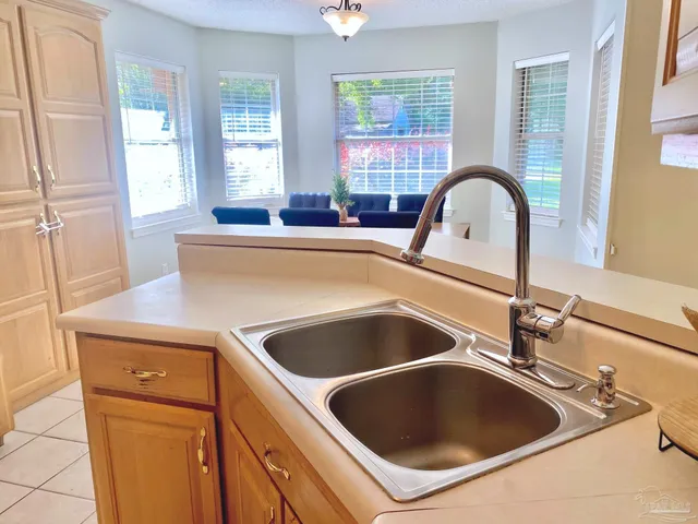a kitchen with a sink and a stove next to a window