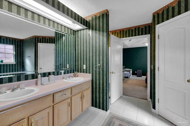 a en suite bathroom with a sink a mirror and shower