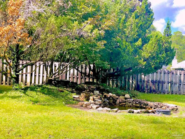 a view of yard with green space and seating area