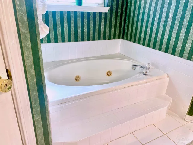 a bathroom with a bathtub and shower