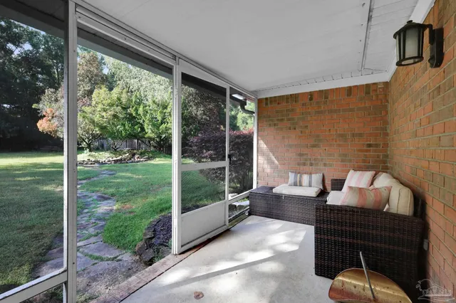 a balcony with furniture and garden view