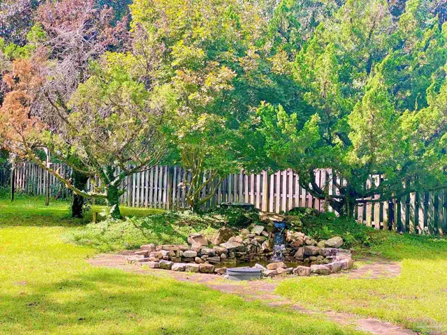 a view of a chair and table in the garden