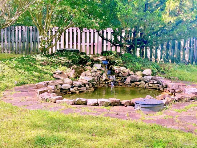 a view of a backyard with plants and patio