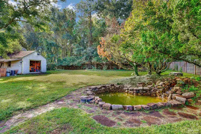 a view of an house with backyard space and swimming pool