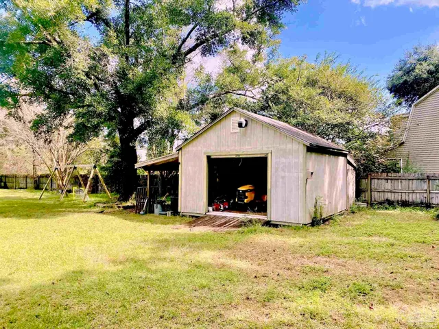 a view of a house with yard and sitting area