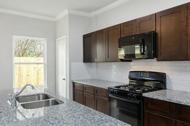 a kitchen with a sink stove and cabinets
