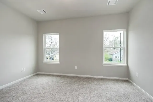 an empty room with windows and closet