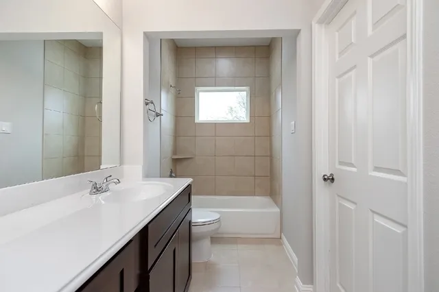 a white bath tub sitting next to a toilet