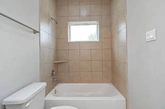 a view of an empty room and a window