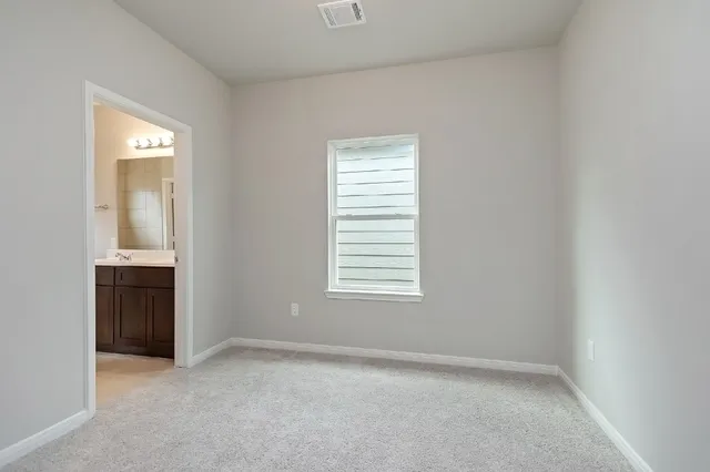 a view of an empty room with closet area