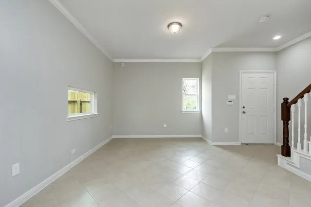 a view of a hallway with wooden floor and windows