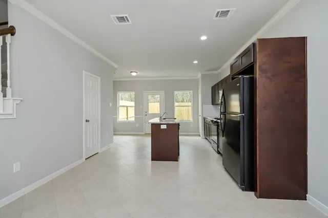 a kitchen with a refrigerator and a sink