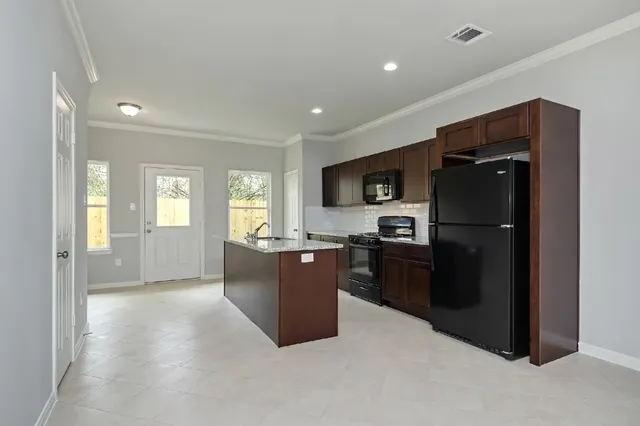 a kitchen with a refrigerator and a sink