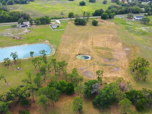 an aerial view of a houses with yard