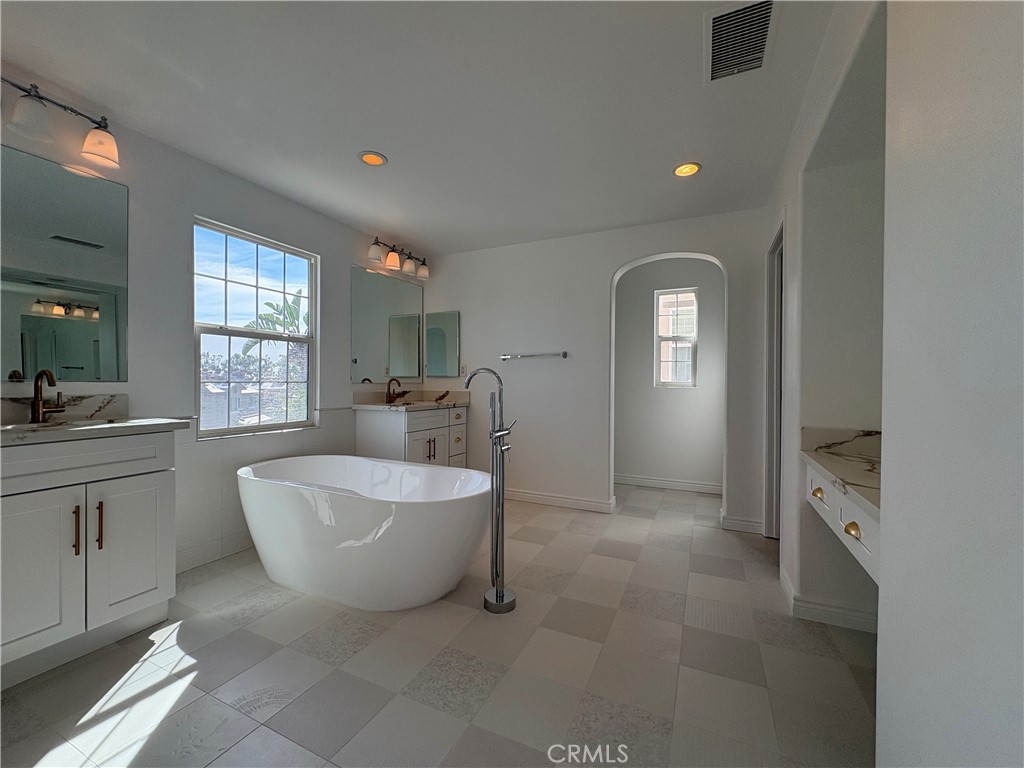 1324 Swan Loop East Upland, CA 91784 - Photo 17 of 27 a spacious bathroom with a double vanity sink a mirror and a bathtub
