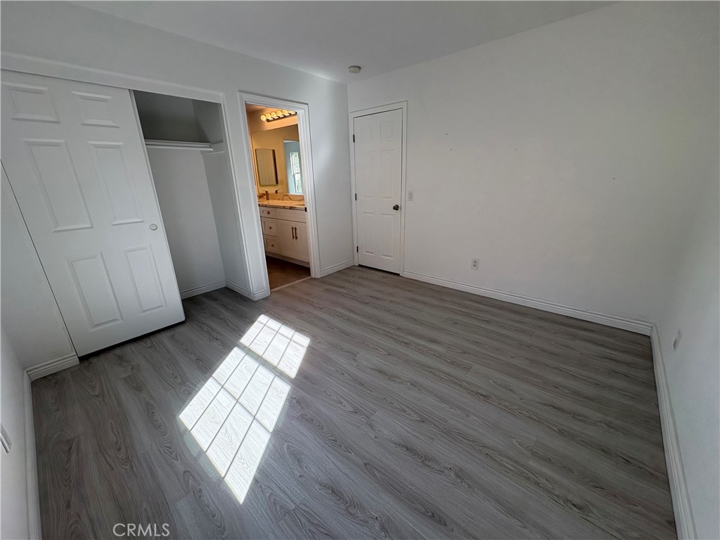 1324 Swan Loop East Upland, CA 91784 - Photo 25 of 27 an empty room with wooden floor and windows