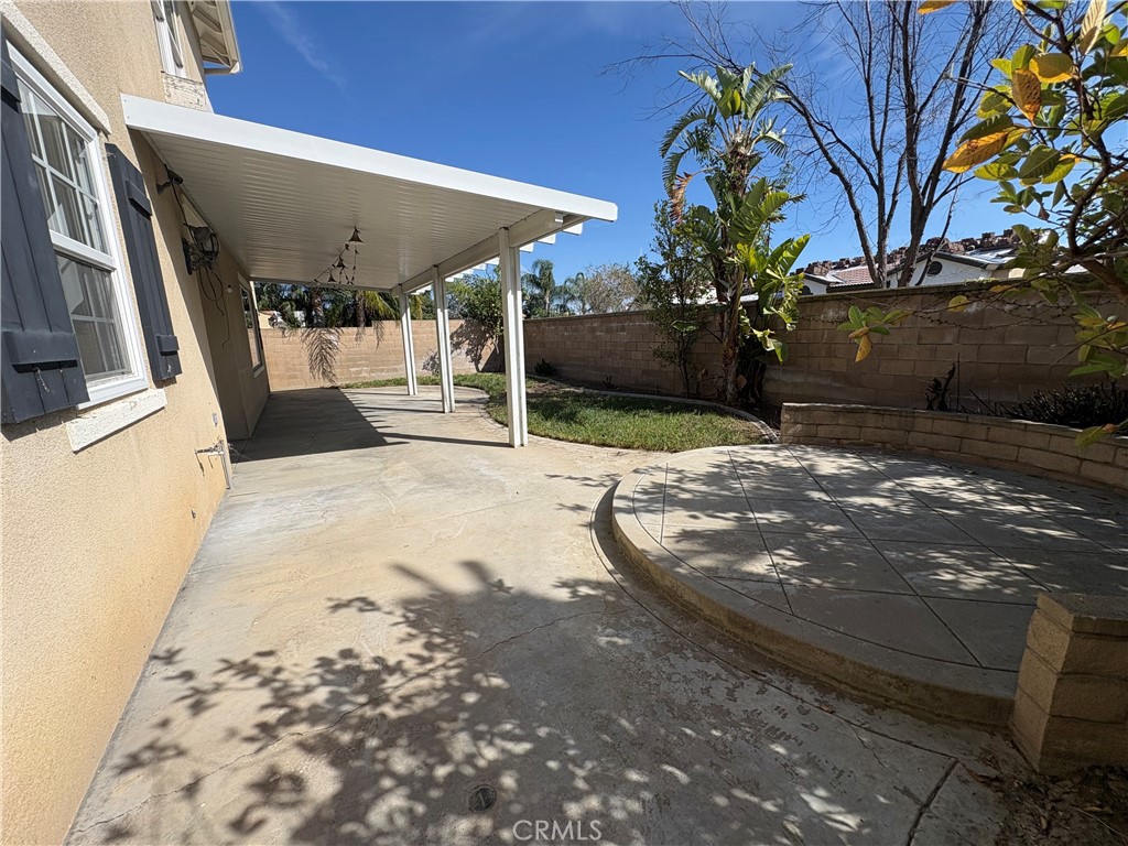 1324 Swan Loop East Upland, CA 91784 - Photo 26 of 27 a view of a backyard with table and chairs under an umbrella