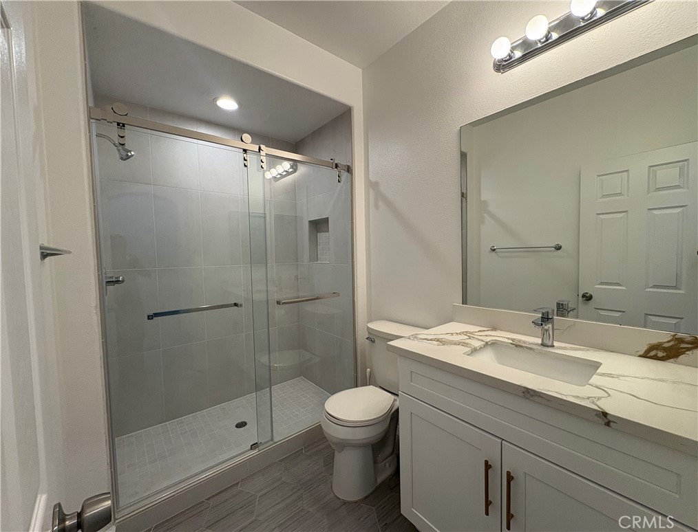 1324 Swan Loop East Upland, CA 91784 - Photo 4 of 27 a bathroom with a shower sink vanity granite and toilet